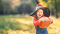 Girl holding a pumpkin at a pumpkin picking field