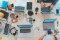 Laptops and phones with people working together